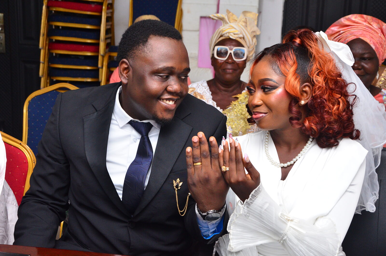 Oluwafunmibi and Olumurewa showing their wedding rings